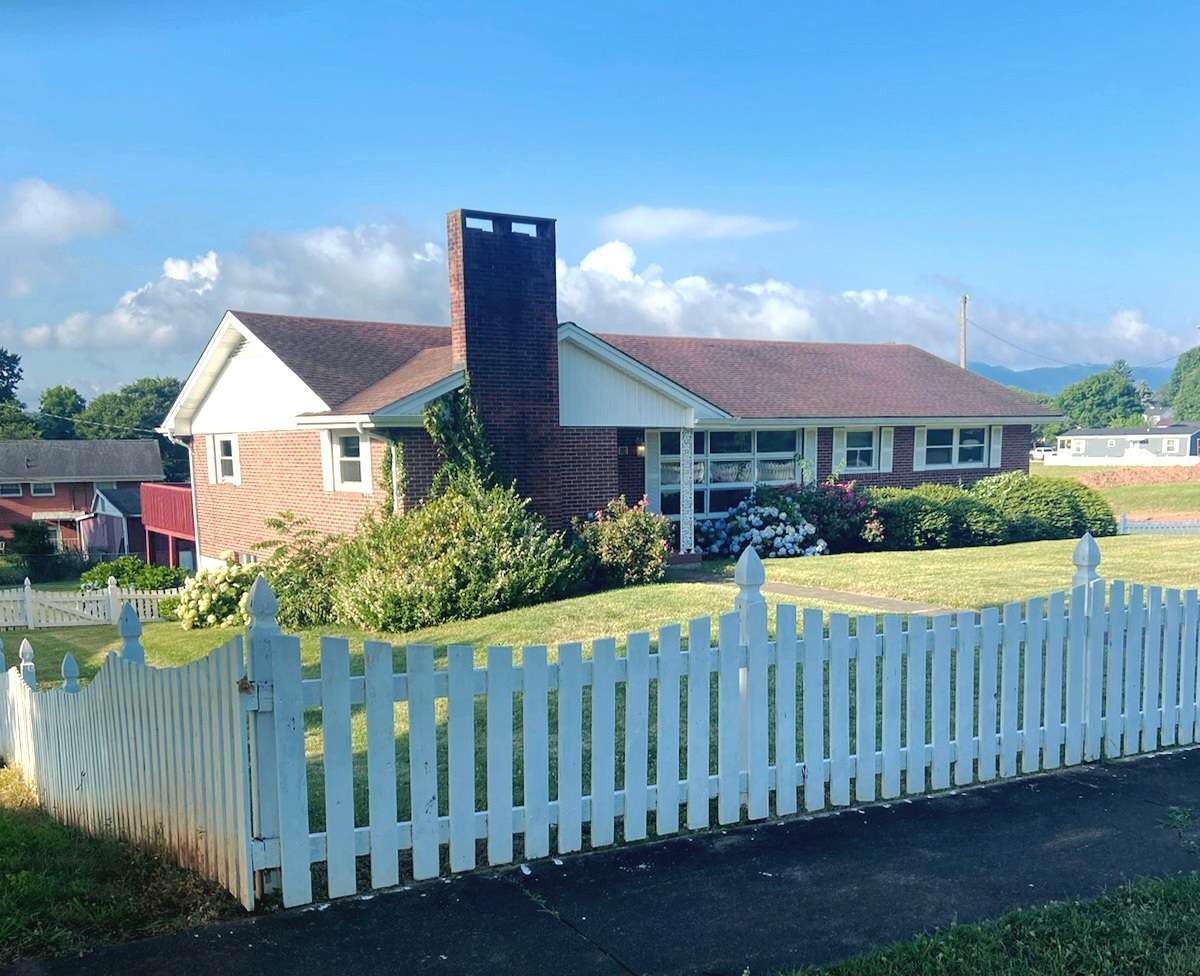 a view of a house with wooden fence