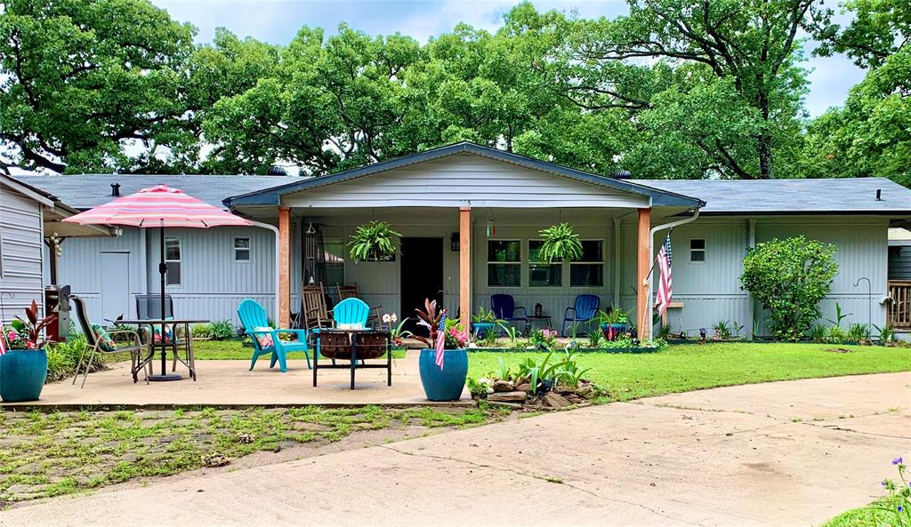 a view of a house with a yard and sitting area