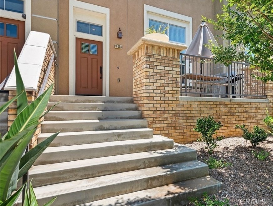 a view of front door of house with stairs