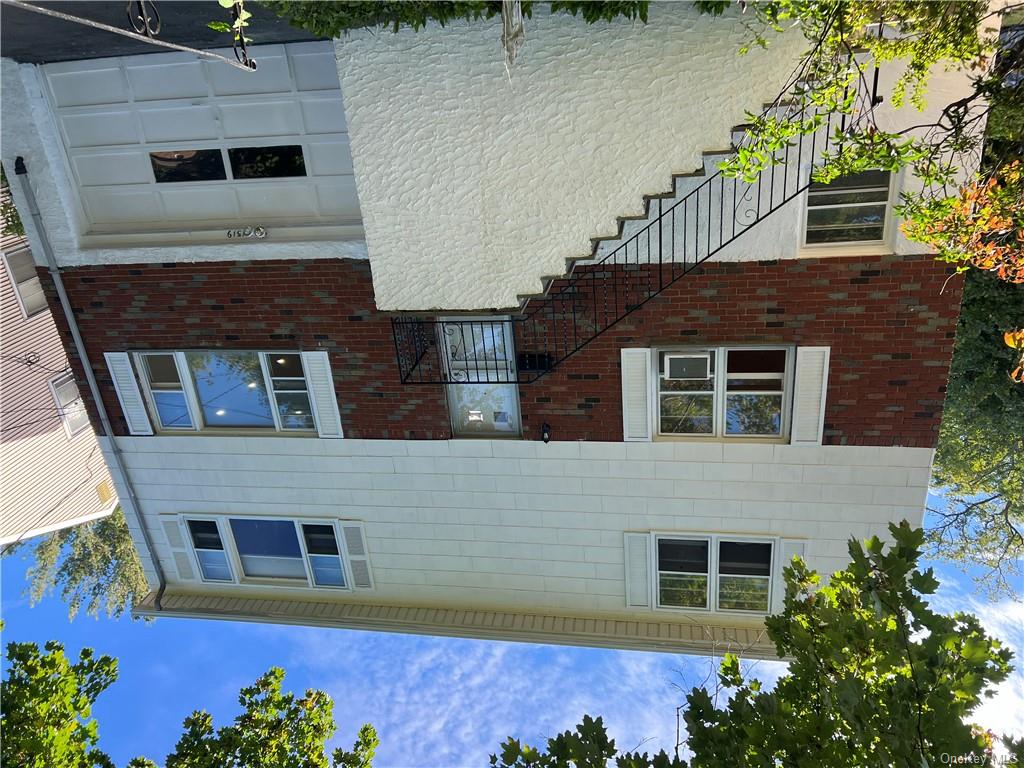 View of front of home featuring cooling unit and a garage