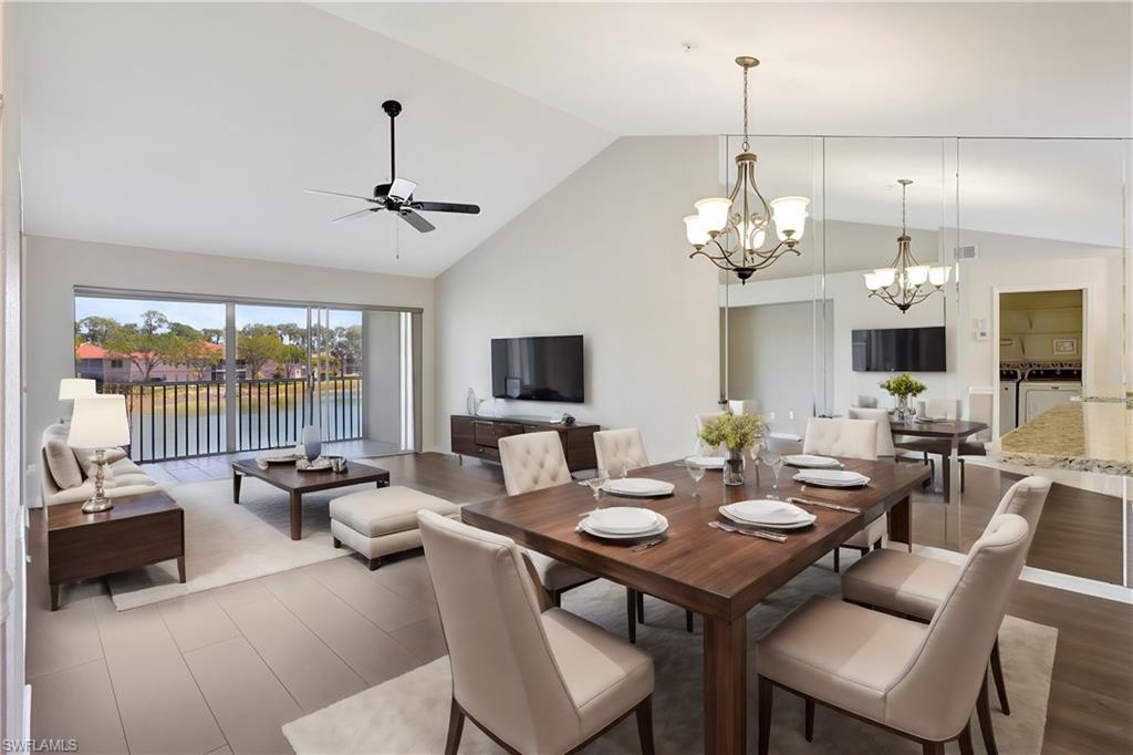 a view of a dining room with furniture wooden floor and chandelier