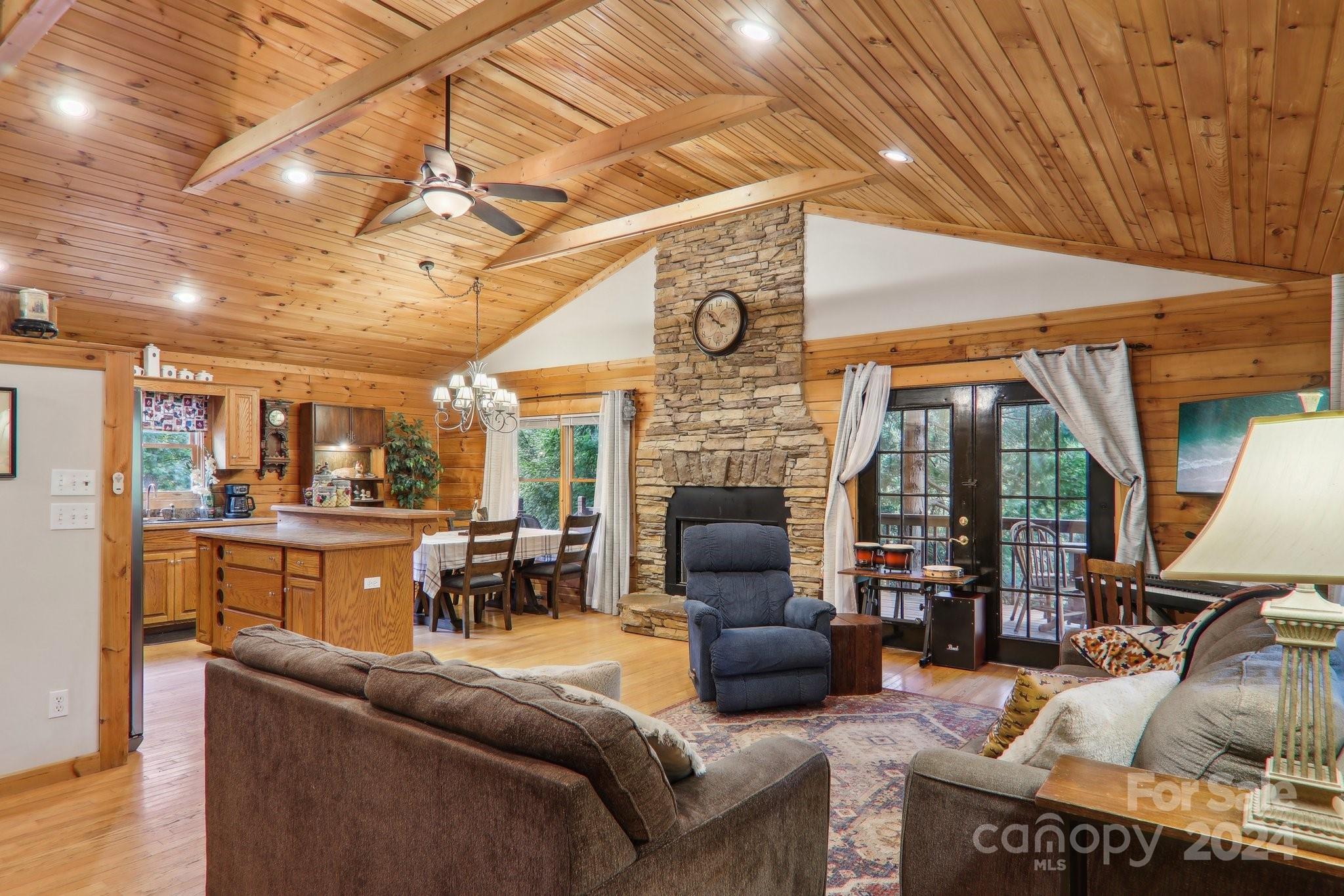 a living room with furniture a fireplace and a table