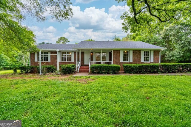 a front view of house with yard and green space