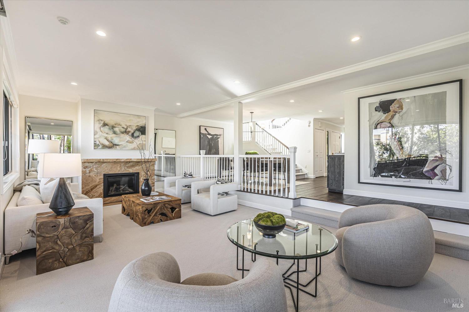 a living room with furniture mirror and a fireplace