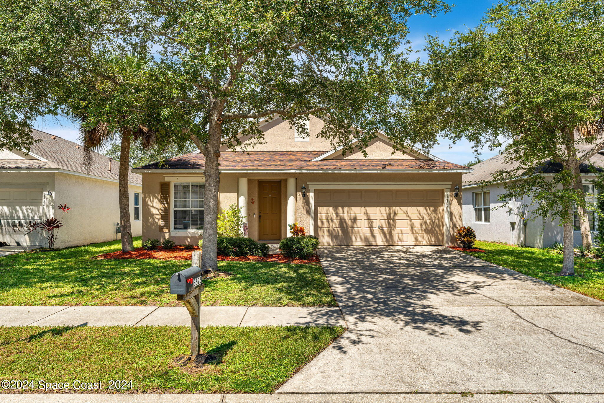 a front view of a house with a yard