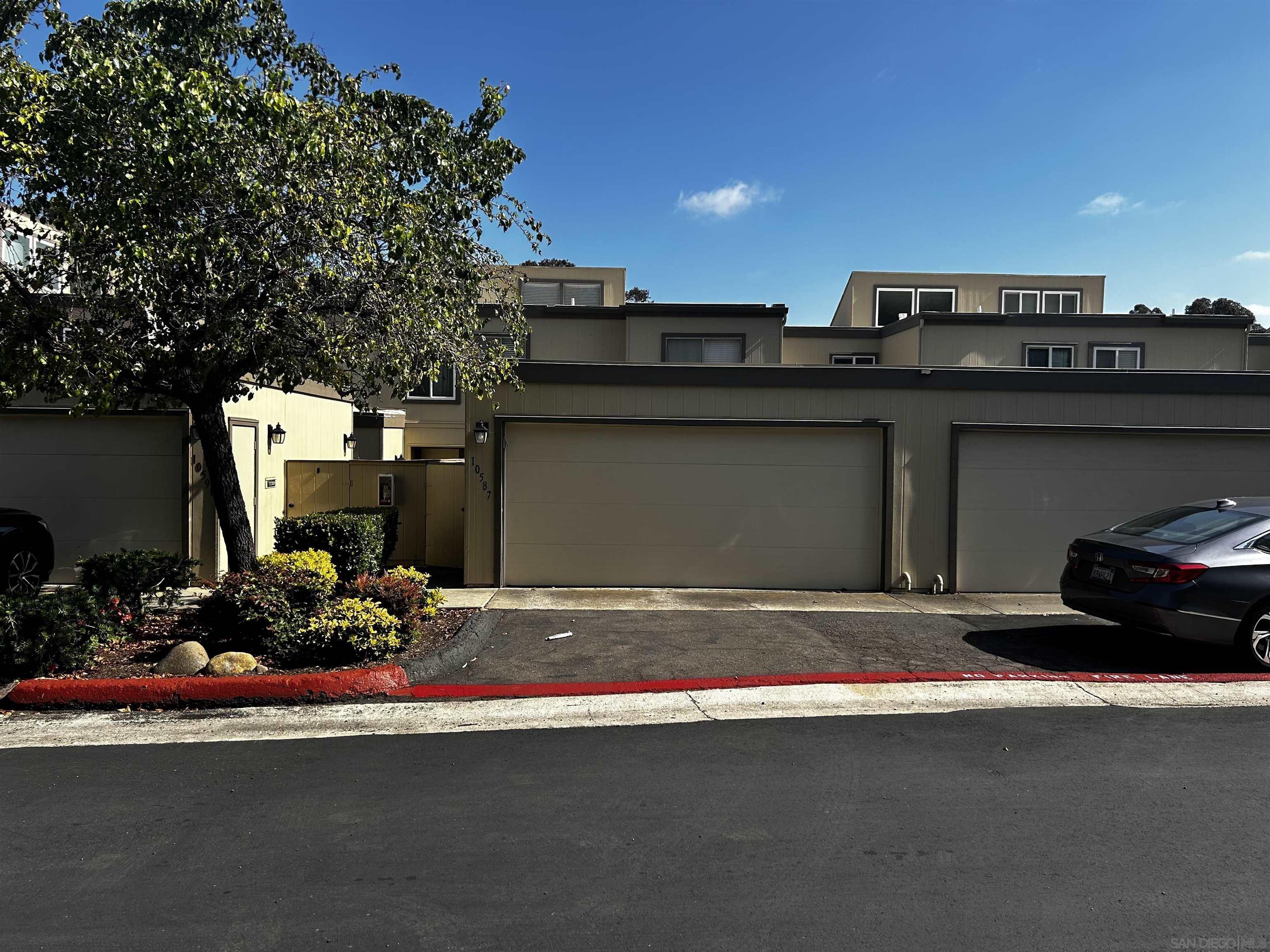 a front view of a house with lots of garage and a car parked