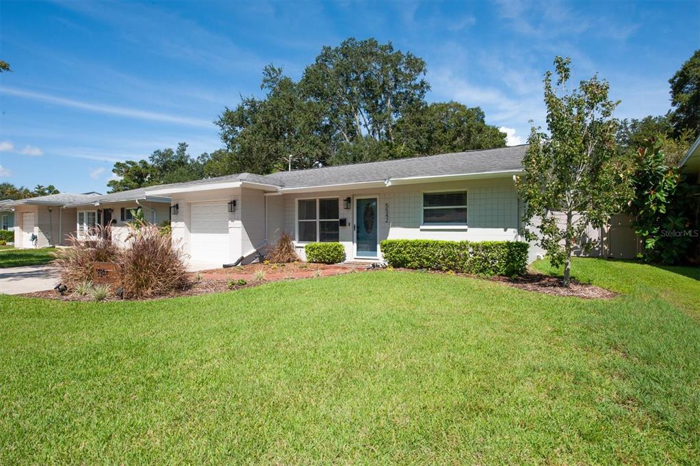 a front view of house with yard and green space