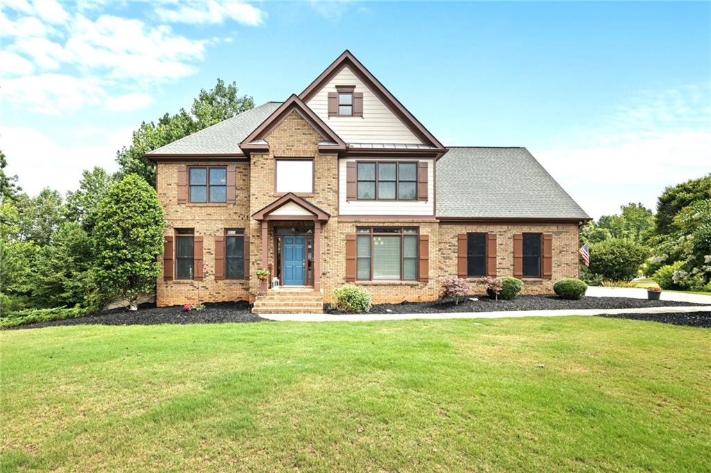 a front view of a house with a yard