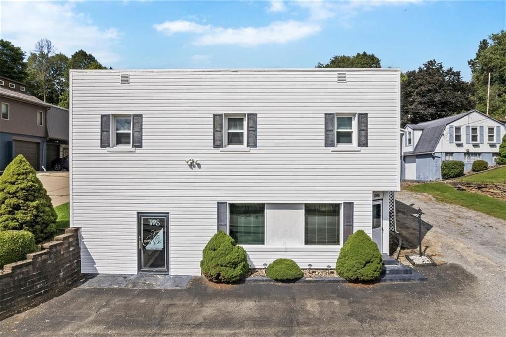 This property includes 2 buildings. The first is in the foreground & the second can be seen in the background on the right (blue & white).