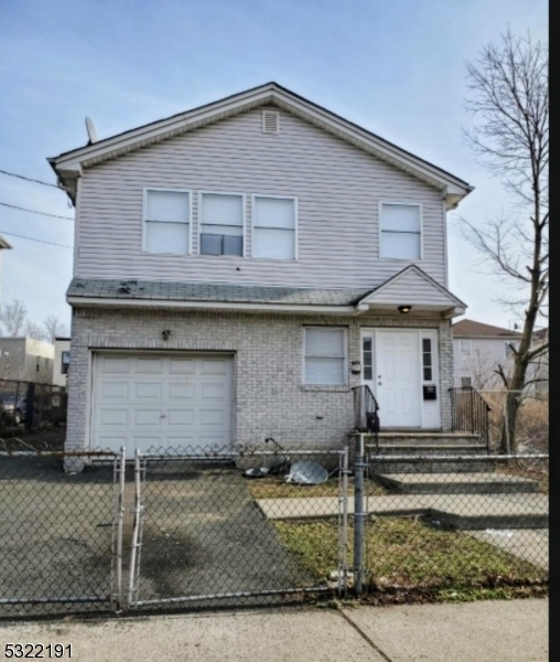 a front view of a house with garage