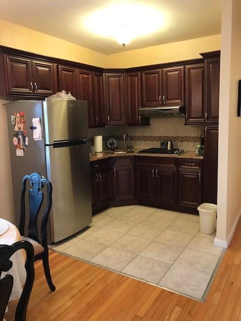 a kitchen with stainless steel appliances granite countertop a refrigerator sink and cabinets