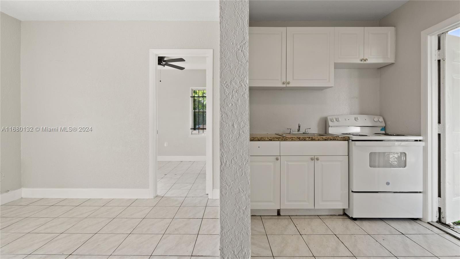 a kitchen with white cabinets and white appliances