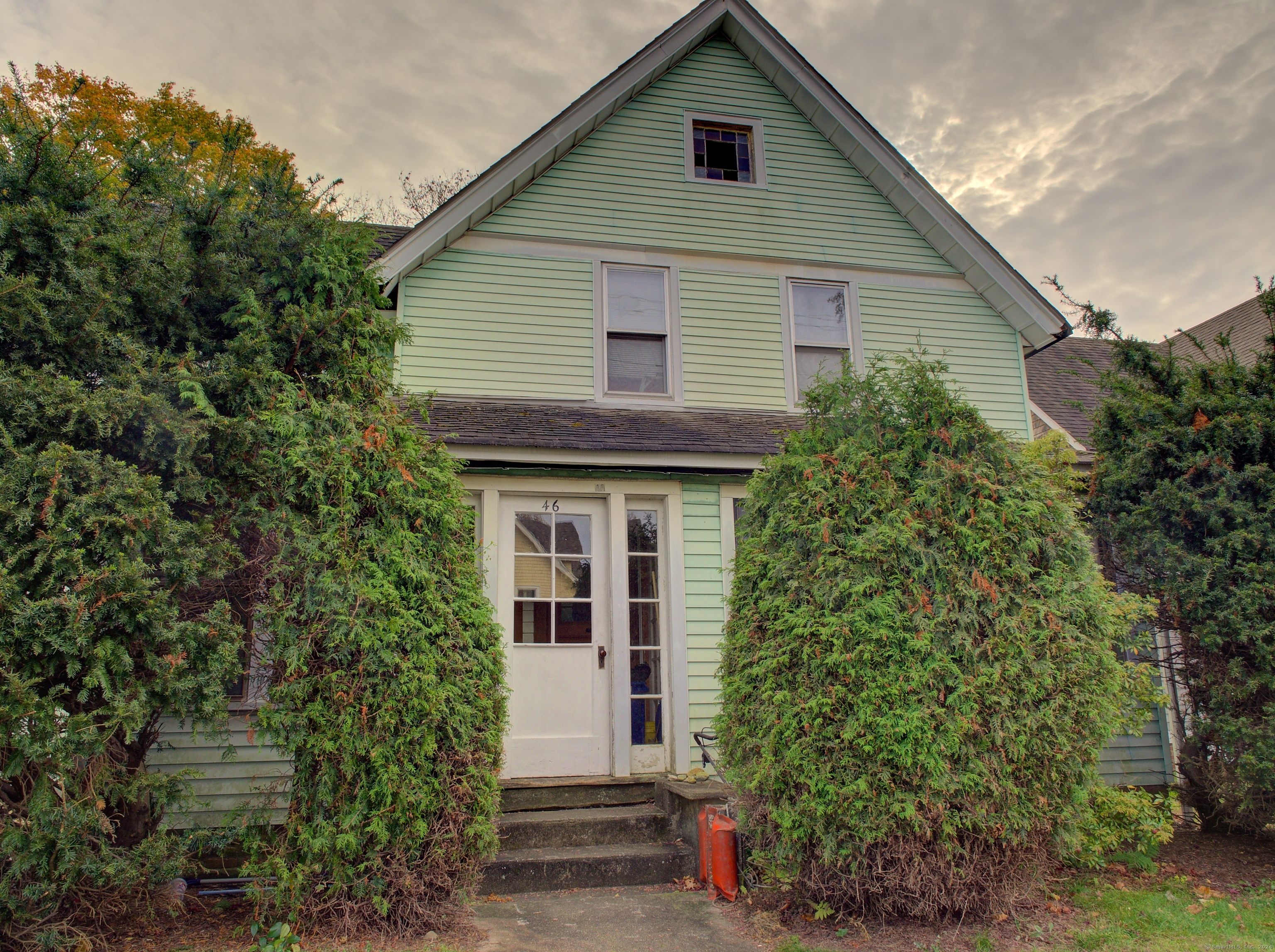 a house that has a tree in front of it