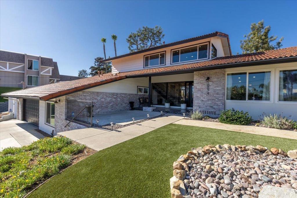 a front view of a house with a garden