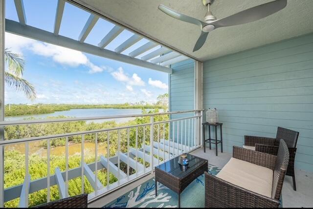 a balcony with furniture and a floor to ceiling window