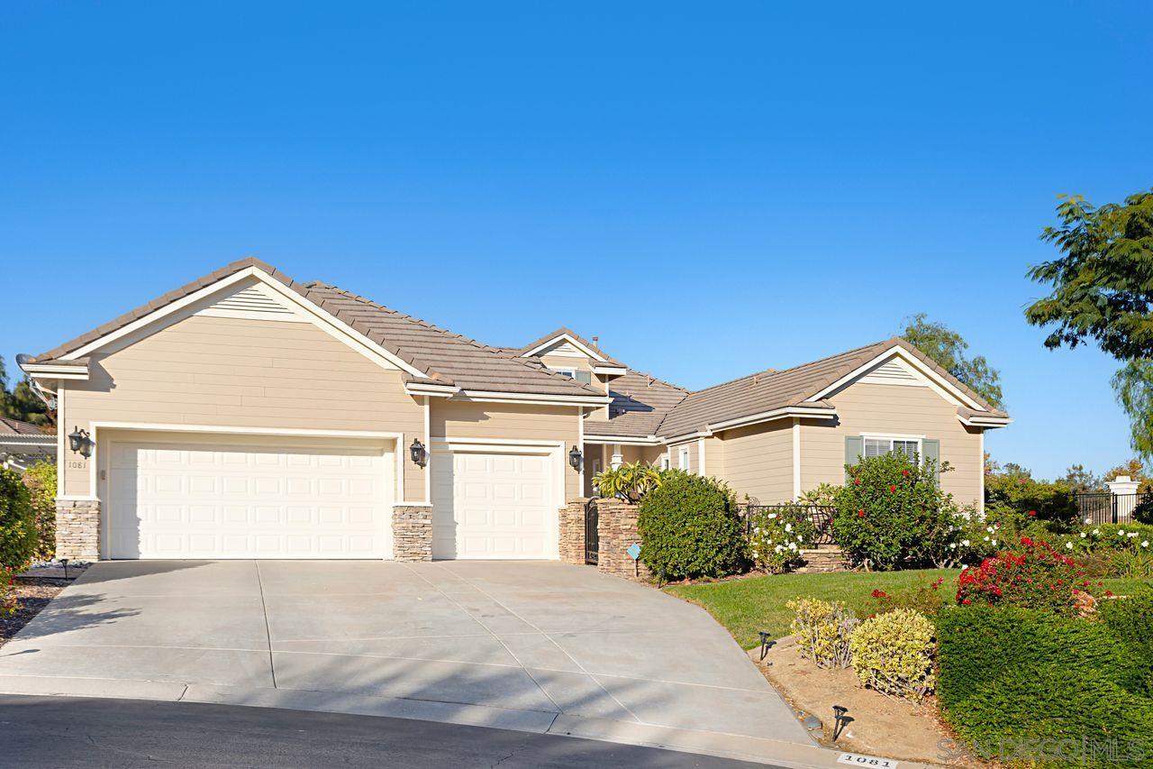 a view of a big house with a big yard and potted plants