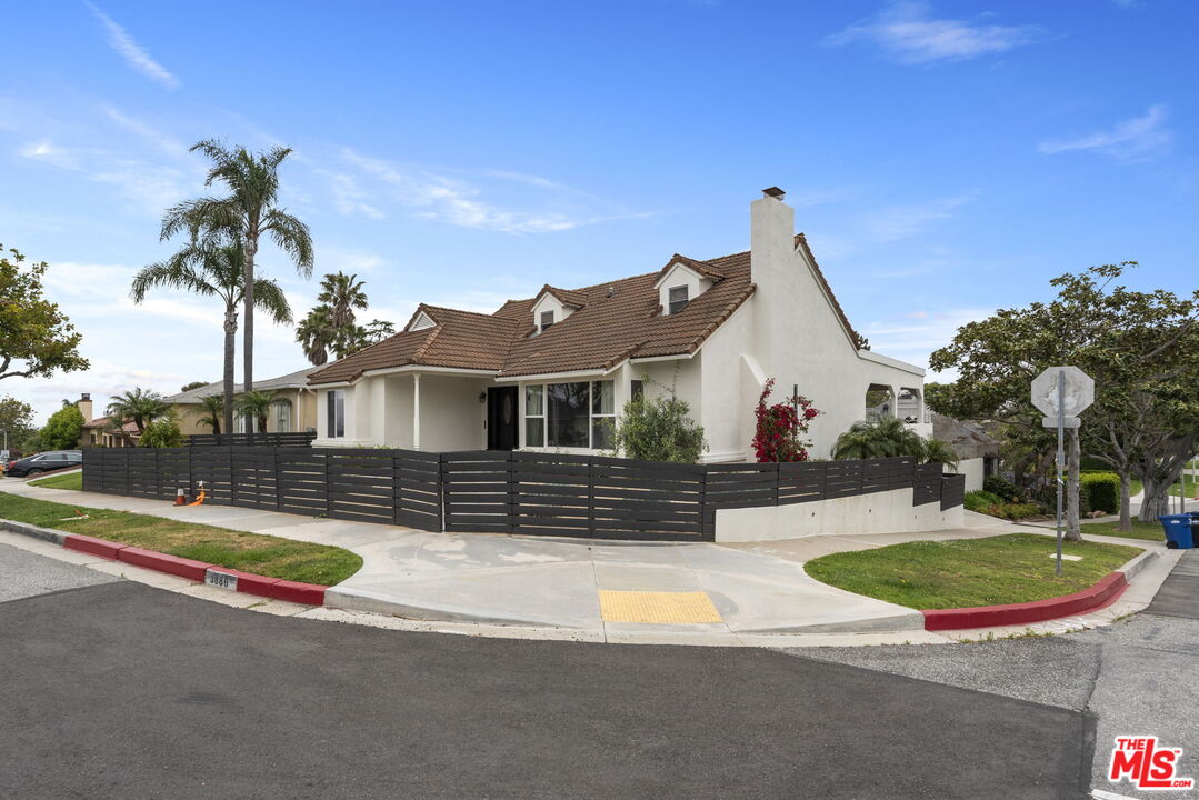 a view of a house with swimming pool and a yard