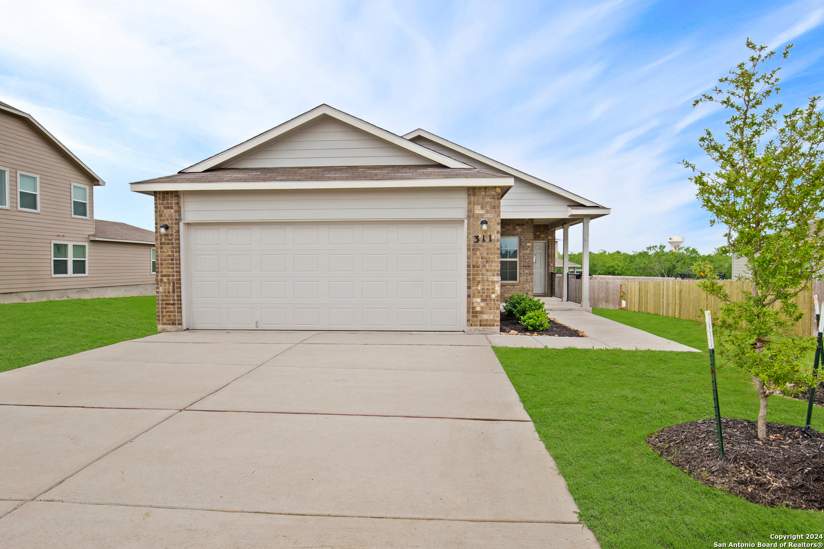 a front view of a house with a yard