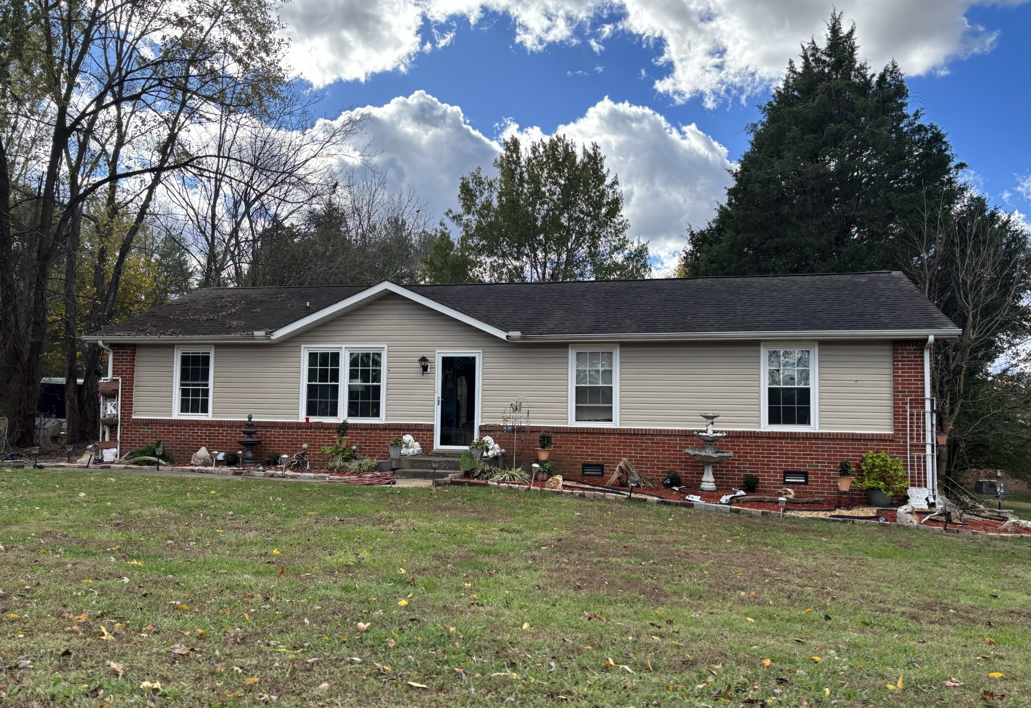 a front view of house with yard and trees