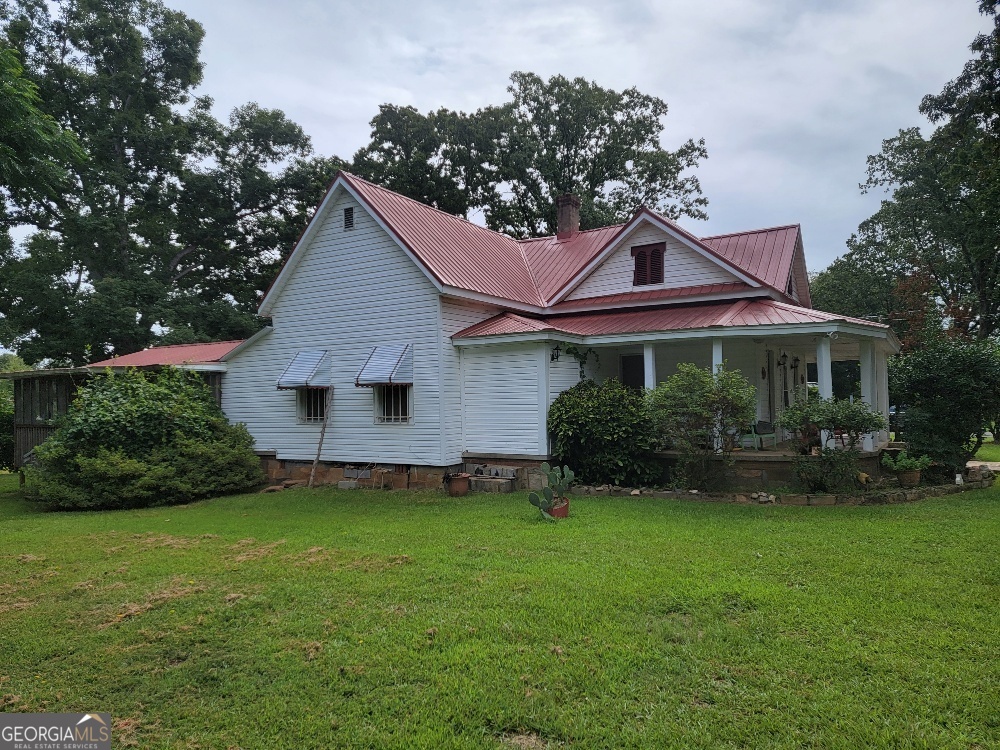 a front view of a house with a garden and yard