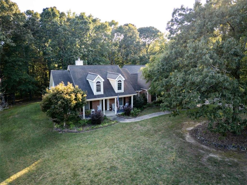 an aerial view of a house with a big yard