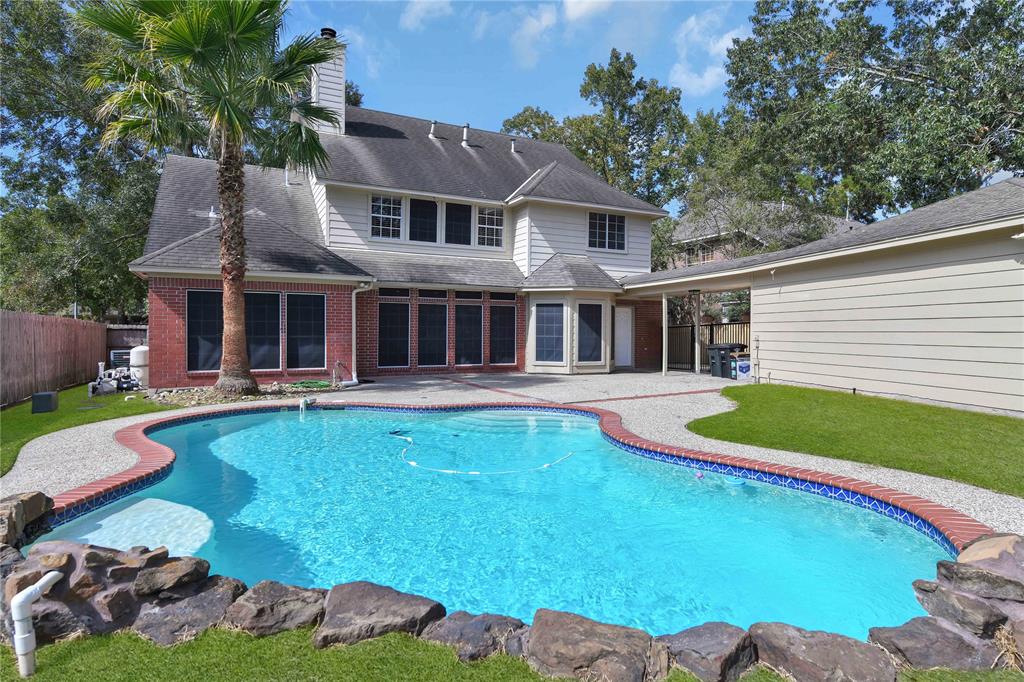 a view of a house with swimming pool and porch