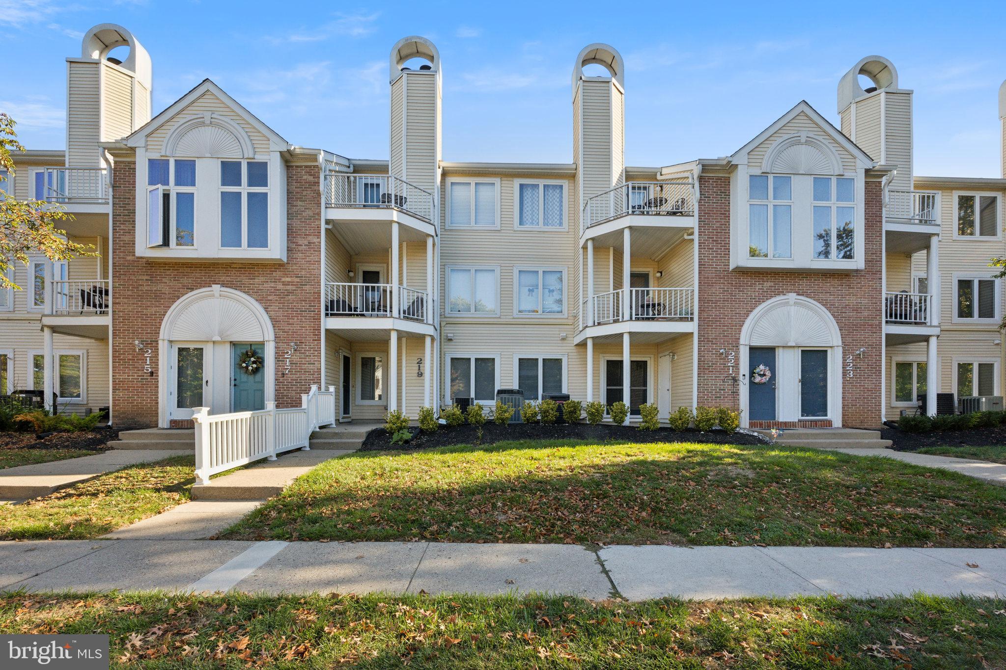 a front view of a residential apartment building with a yard