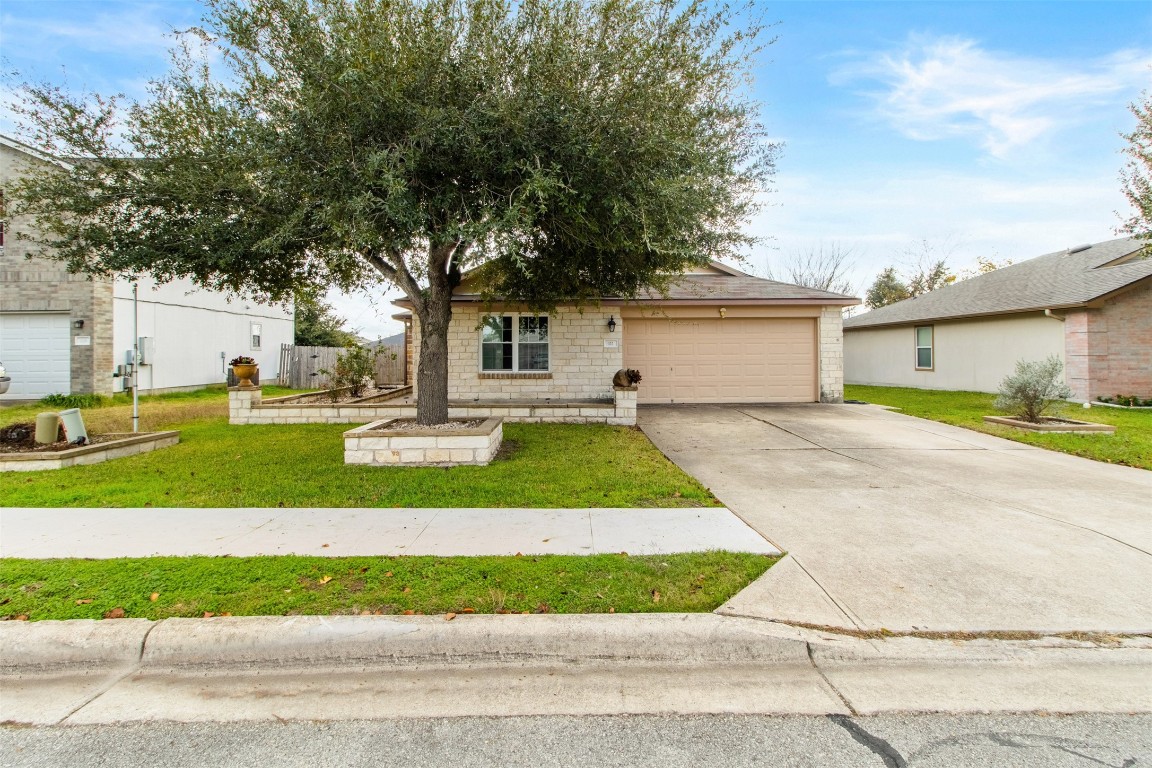 a front view of a house with a yard and garage