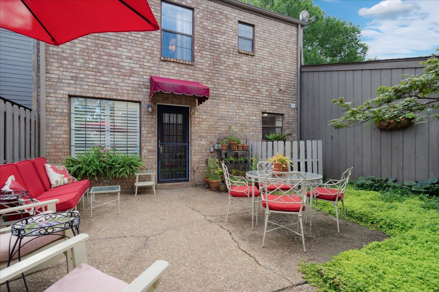 a patio with table and chairs