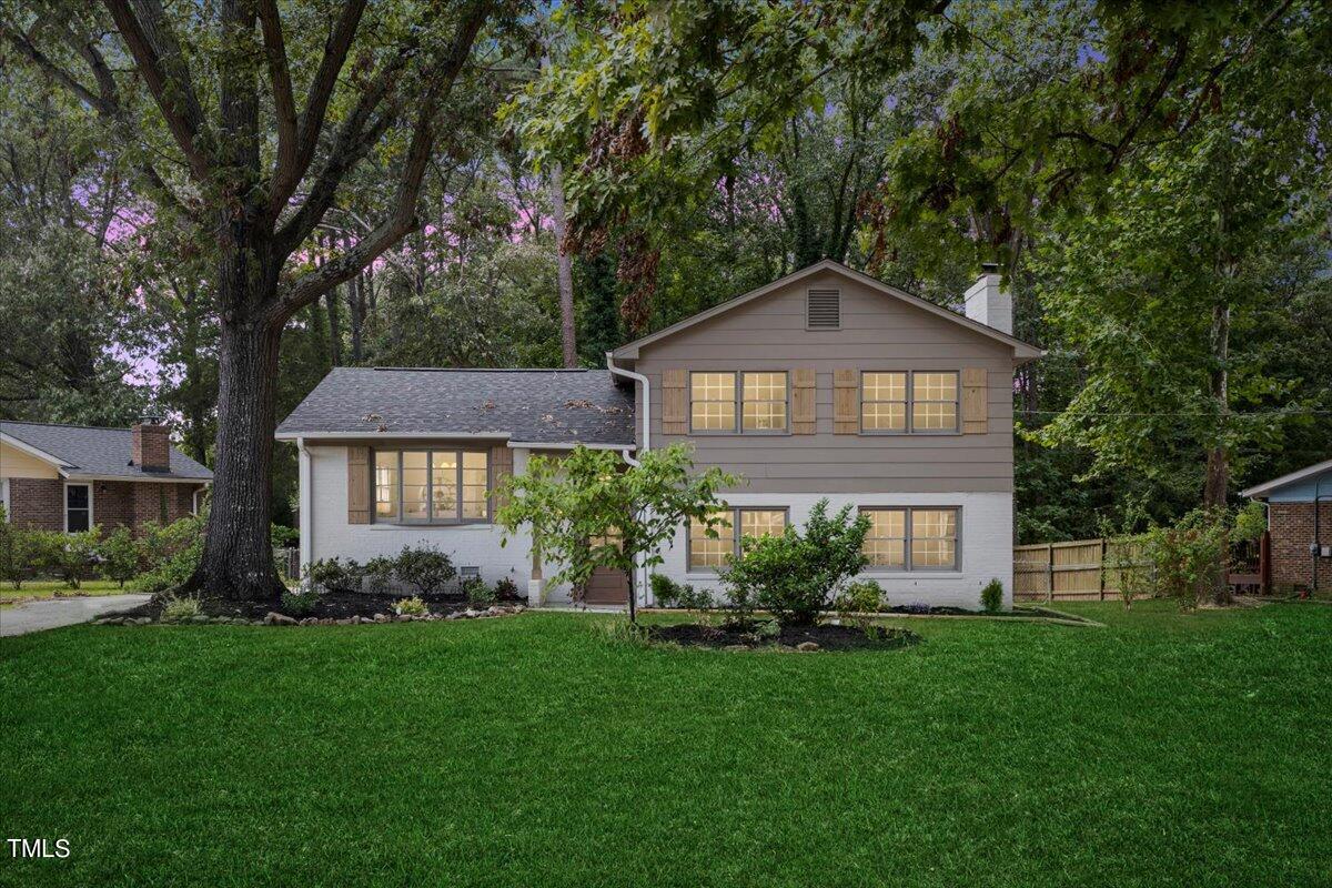 a front view of a house with a garden