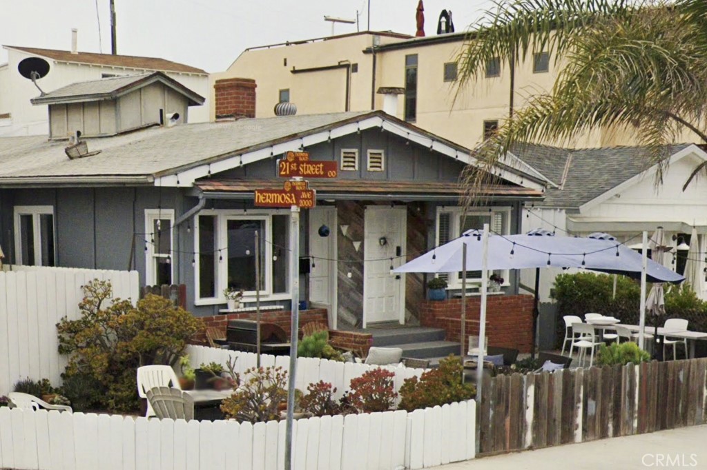 a front view of a house with wooden fence