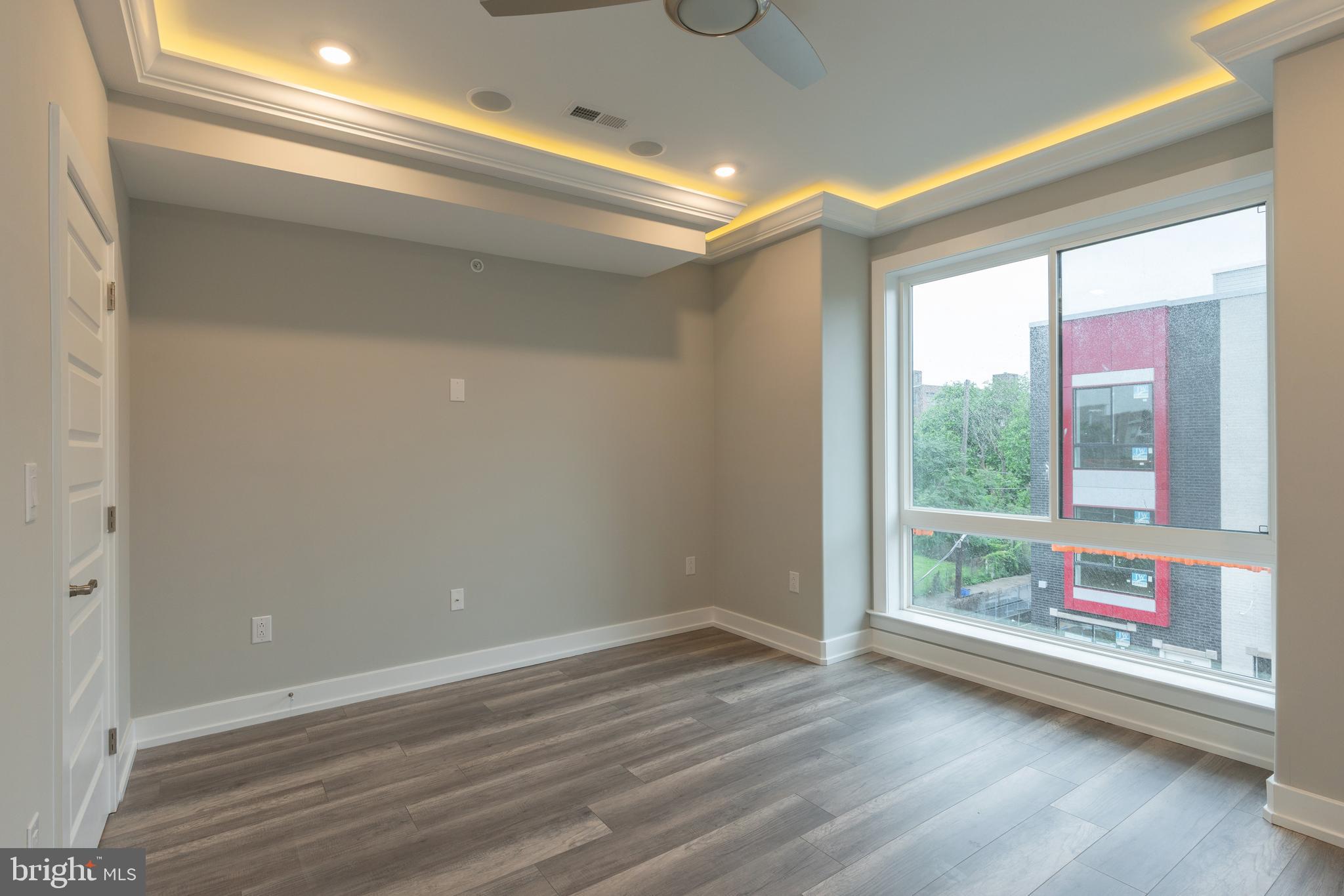 a view of room with window and wooden floor