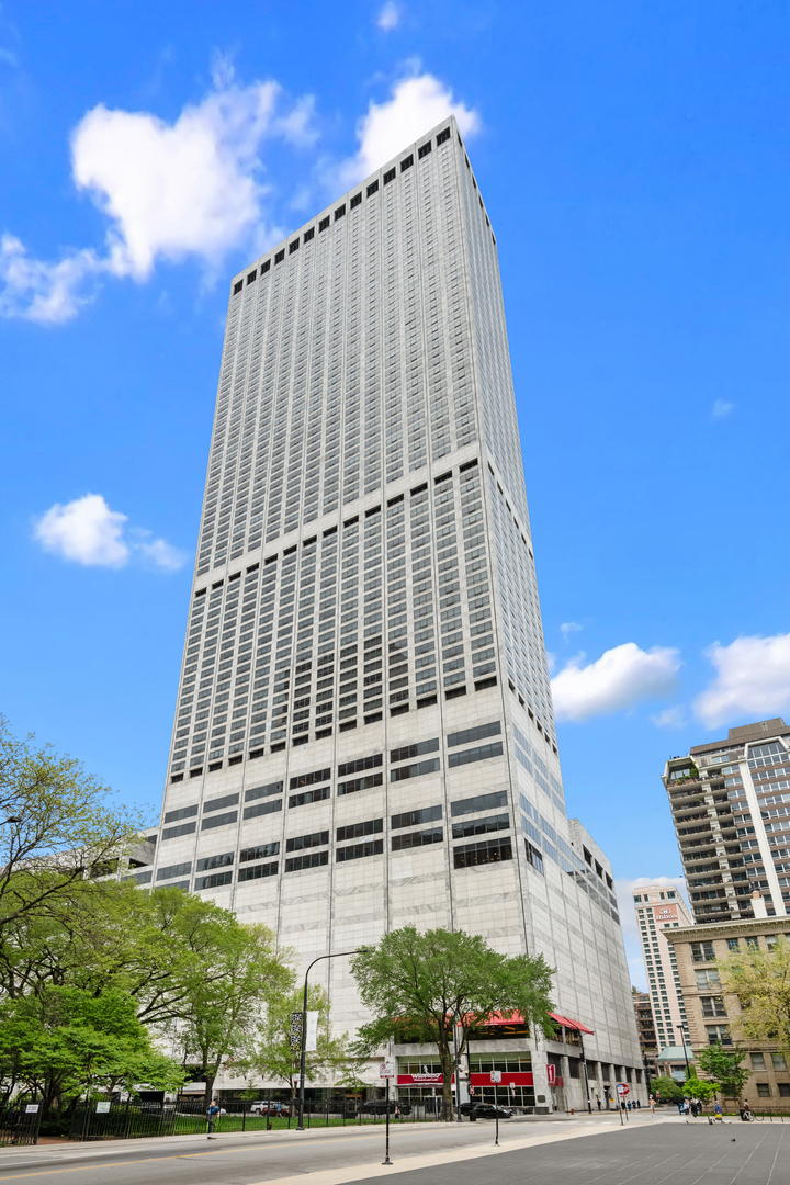 a tall building sitting in front of a building