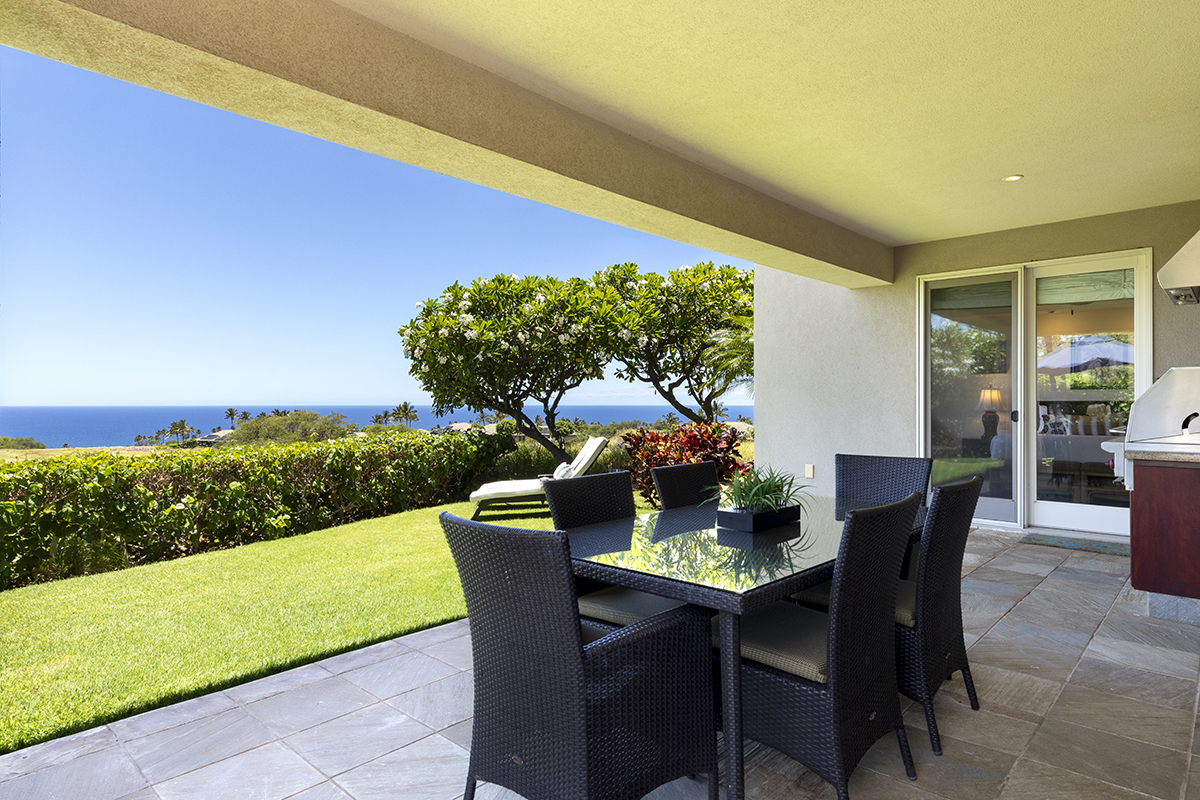 a view of an outdoor dining space with furniture and garden