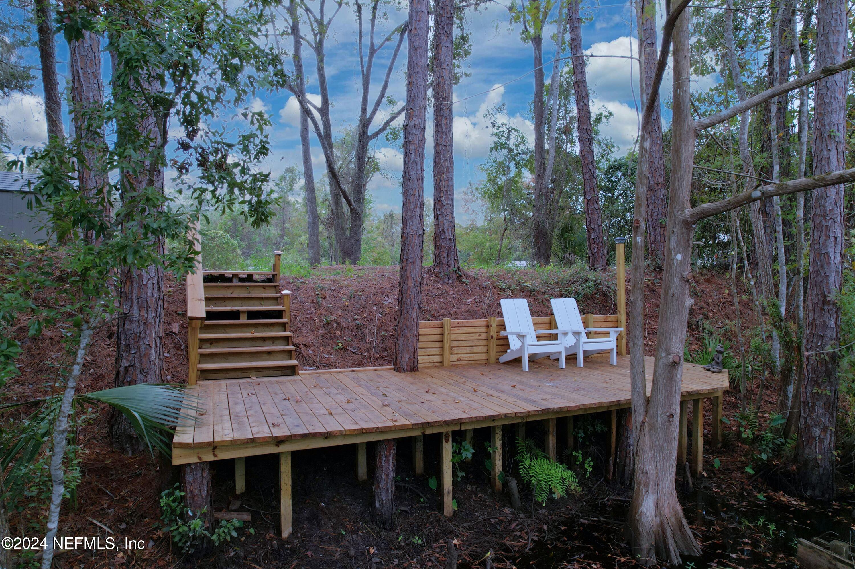 a wooden bench sitting in front of building