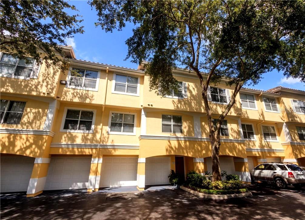 a front view of a residential apartment building with a yard