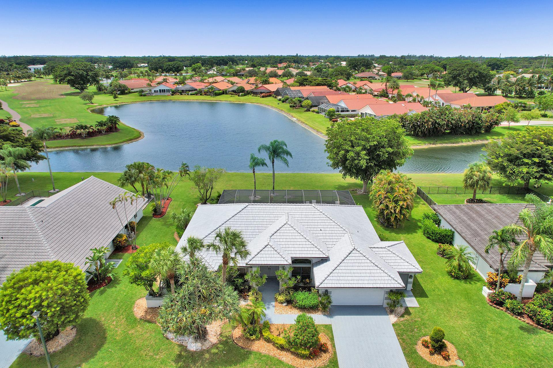 an aerial view of residential houses with outdoor space and lake view