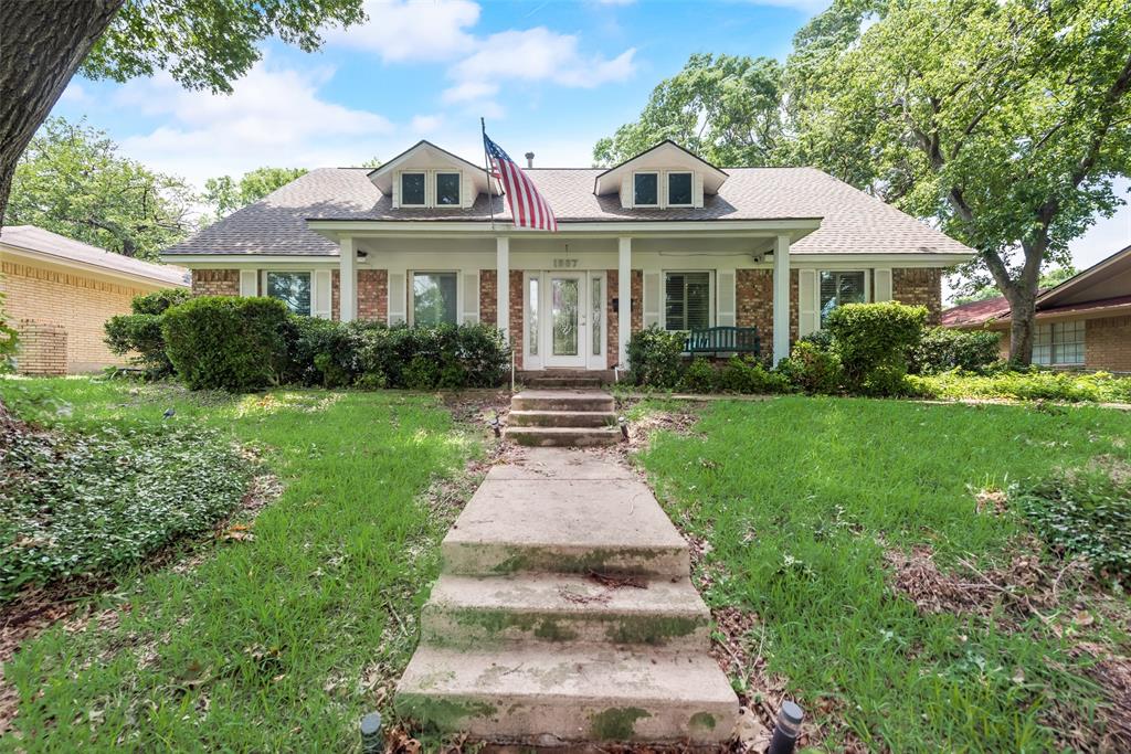 a front view of a house with yard and green space