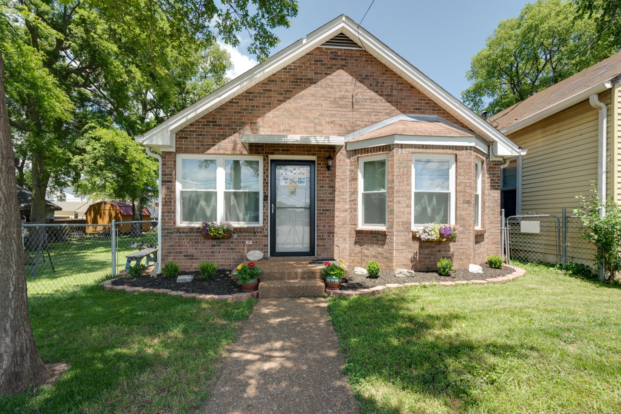 a view of a house with a yard and plants