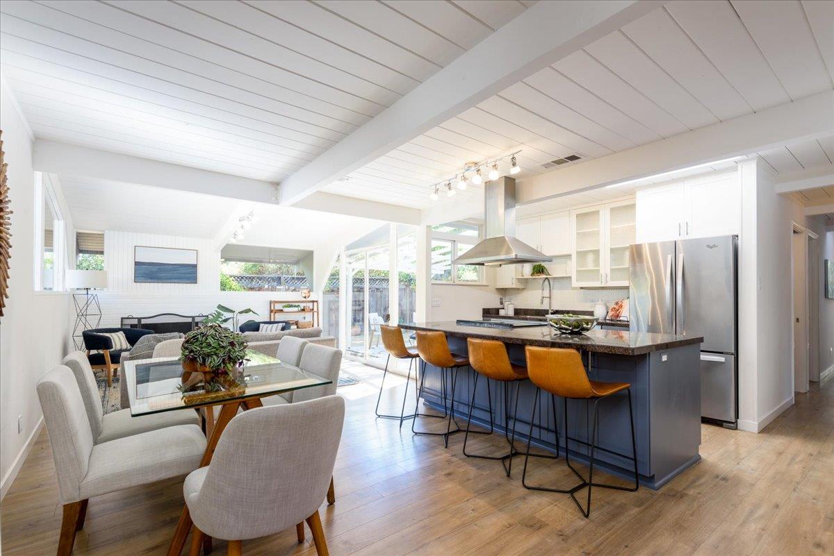 a dining room with furniture a rug and wooden floor