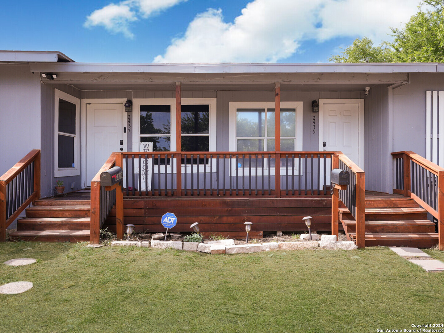 a view of a house with backyard and porch