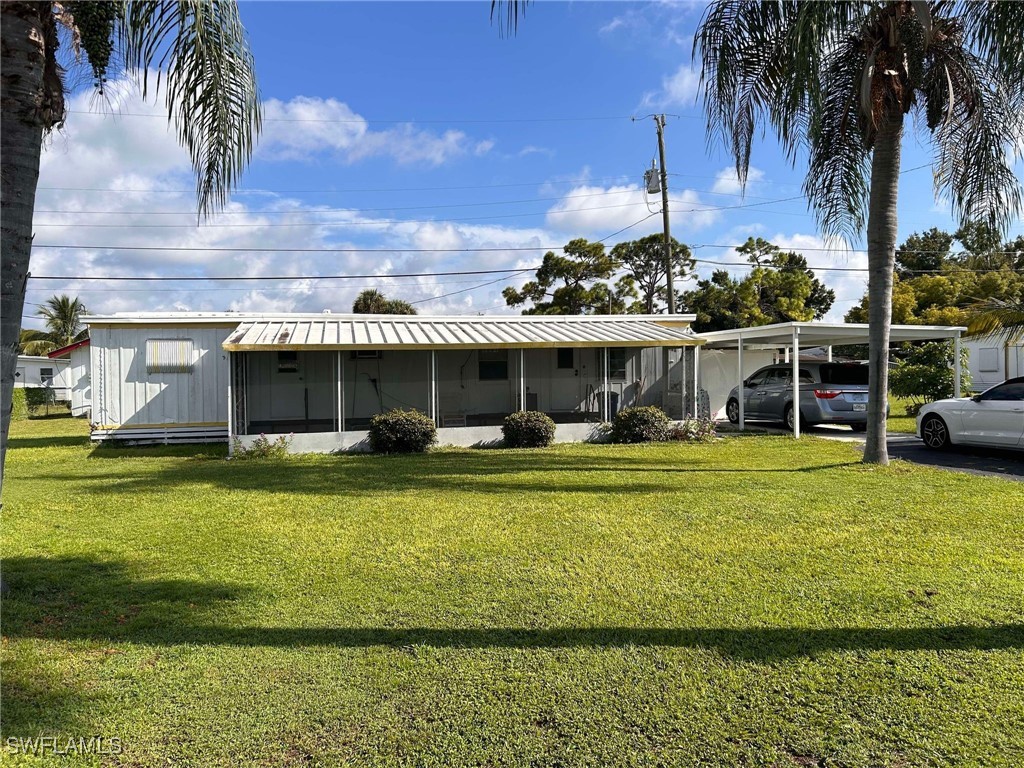 a front view of a house with a garden and lake view