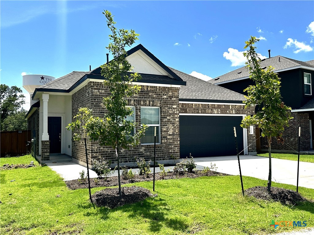 a front view of a house with a yard