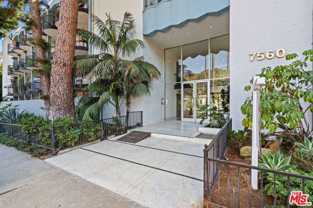 a couple of potted plants in front of door