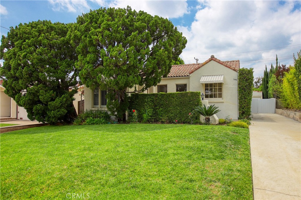 a front view of a house with a garden