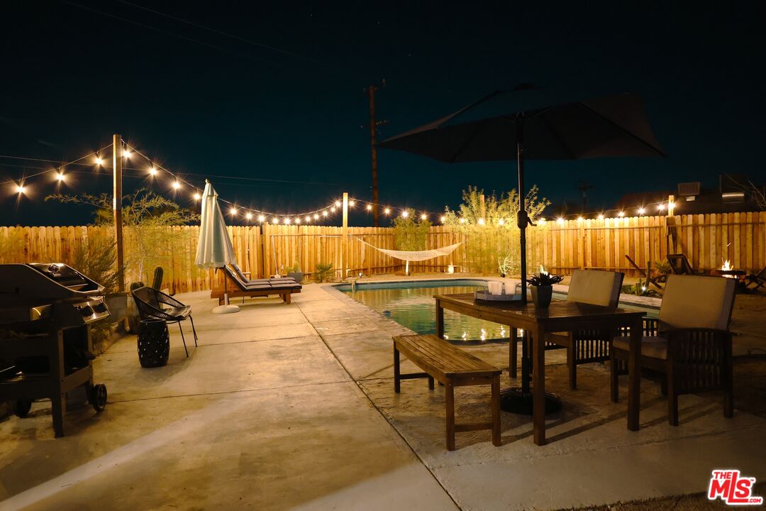 a view of swimming pool with outdoor seating