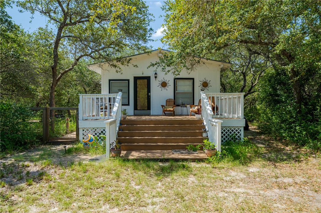 a view of a house with a yard chairs and a table and chair