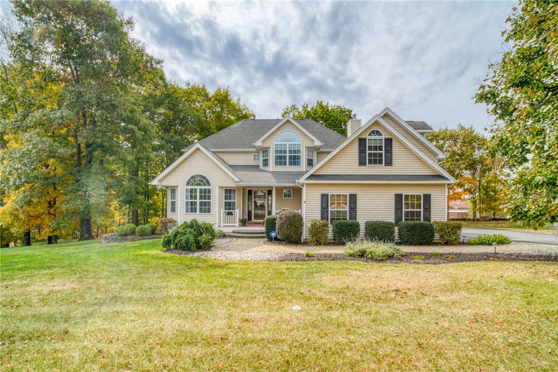 View of front of property featuring a front yard and covered porch