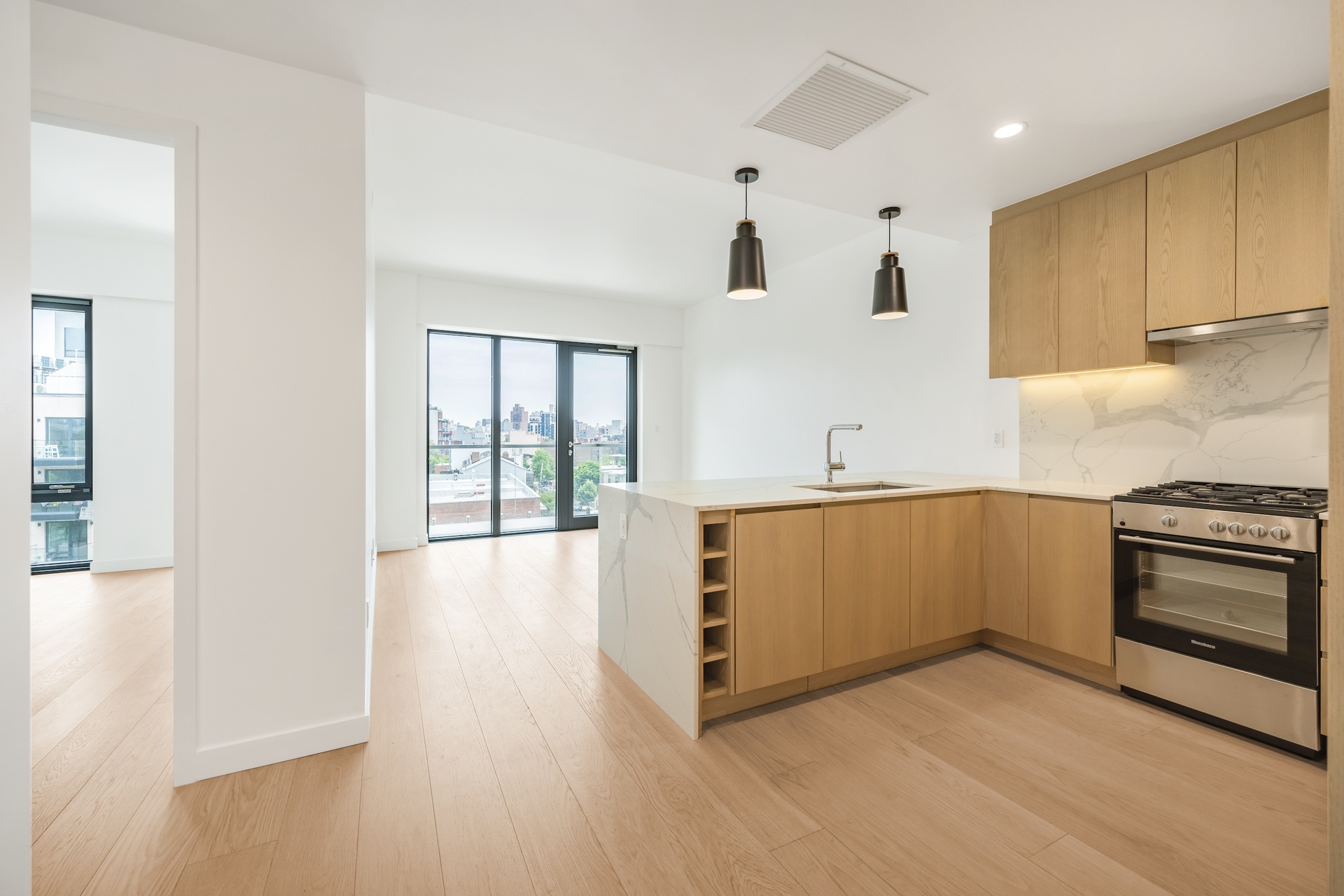 a kitchen with stainless steel appliances white cabinets and wooden floor