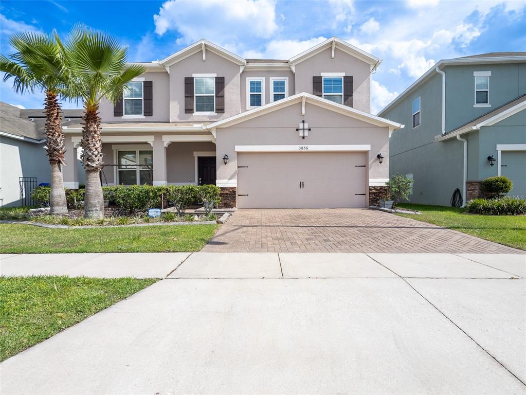 a front view of a house with a yard and garage